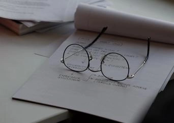 Glasses on a stack of papers