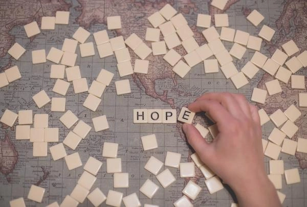 The word "hope" spelled out on scrabble board