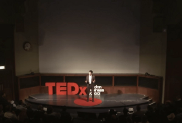 Alex Edmans delivering a Ted Talk in London discussing corporate social responsibility
