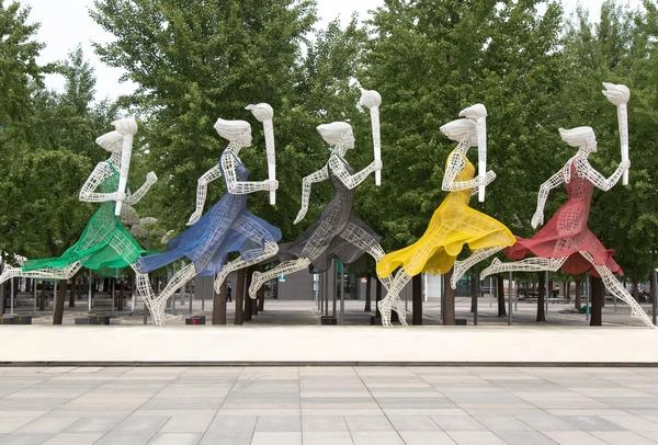 5 metal statues holding olympic torches in downtown Atlanta, Georgia