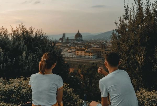 A young couple overlooking from afar the duomo in Florence, Italy.