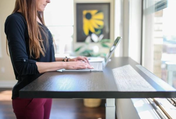Woman completing her work at a standing desk